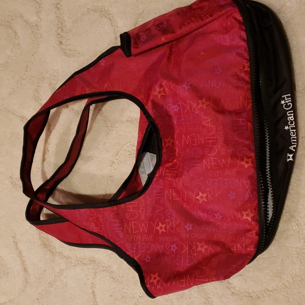 American Girl mini doll and bity baby carrying bag.
